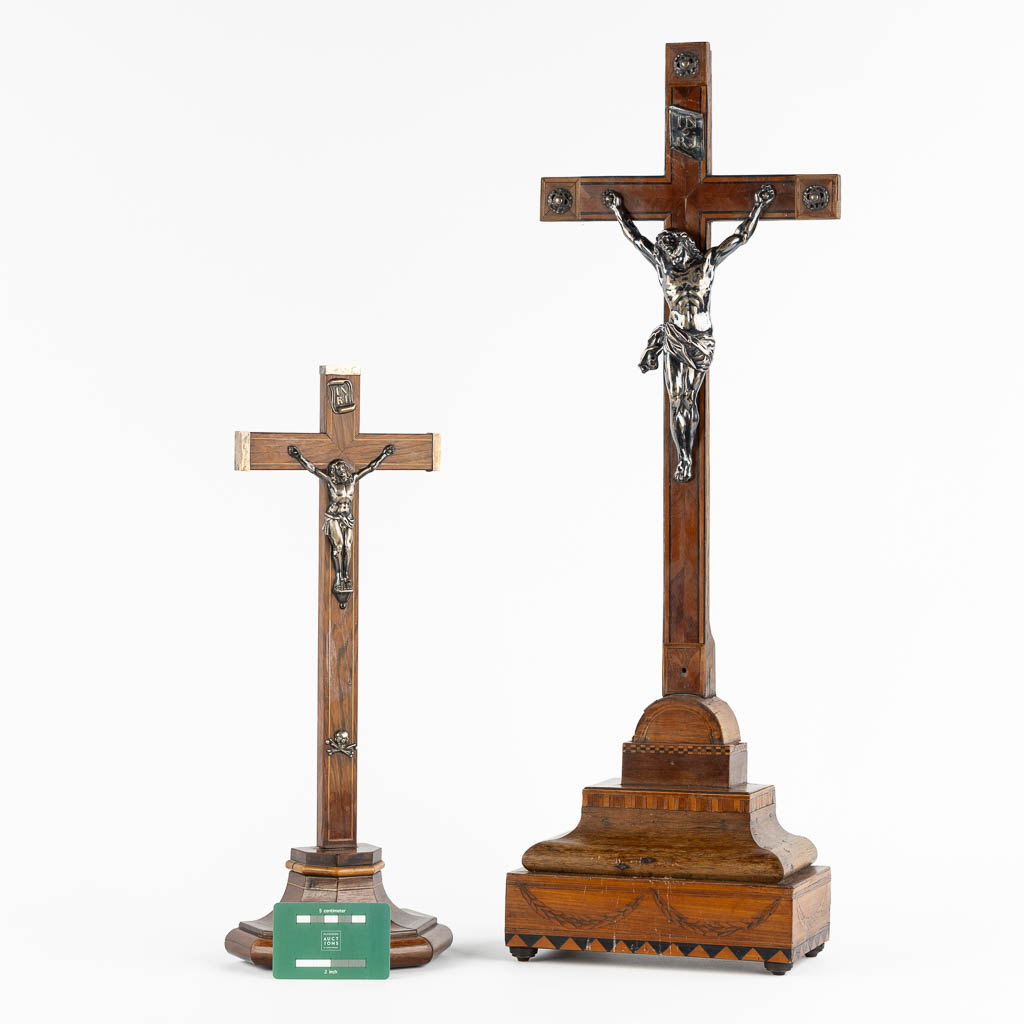 Two crucifixes with a silver Corpus Christi, 19th C. (W:24 x H:70 cm)