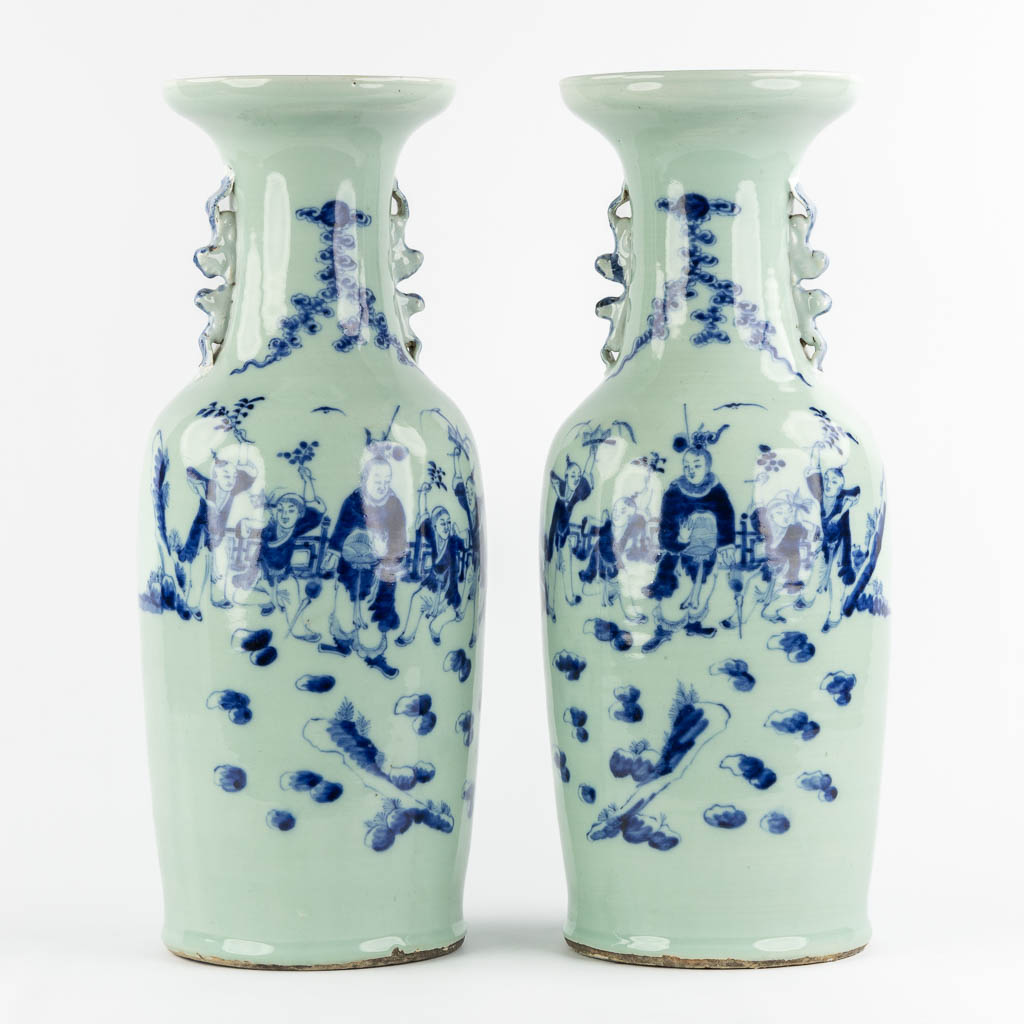 A pair of Chinese vases with a blue-white decor of playing children. (H:57,5 x D:21 cm)