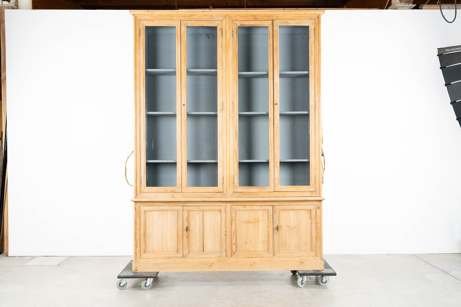 A large display cabinet with 4 glass doors, pine, circa 1880. (L:41 x W:190 x H:253 cm)