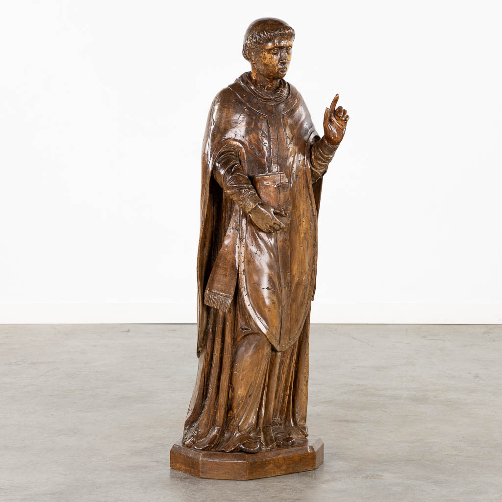 An antique wood-sculptured figurine of Saint Lawrence, 18th/19th C. (L:27 x W:33 x H:106 cm)