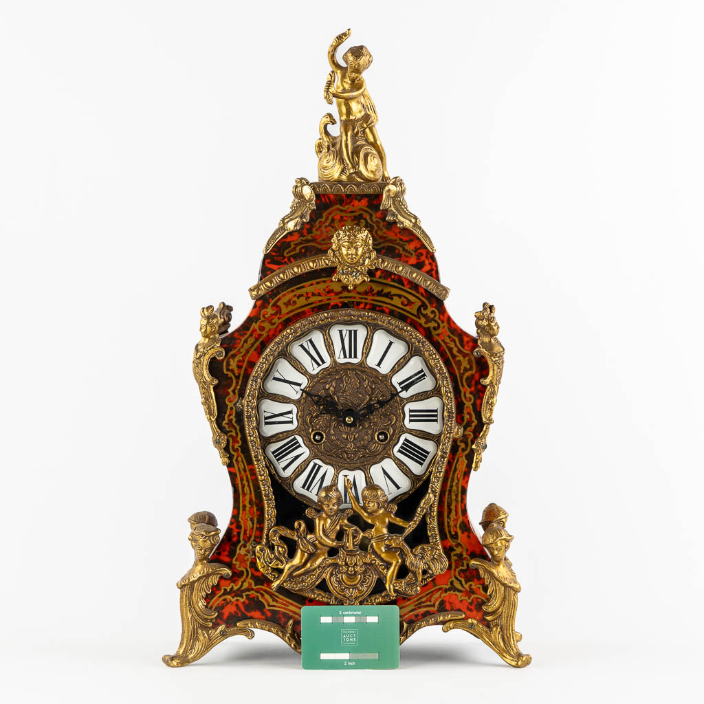 A mantle clock, boulle style marquetry inlay, mounted with gilt bronze. 20th C. (L:15 x W:32 x H:56 cm)