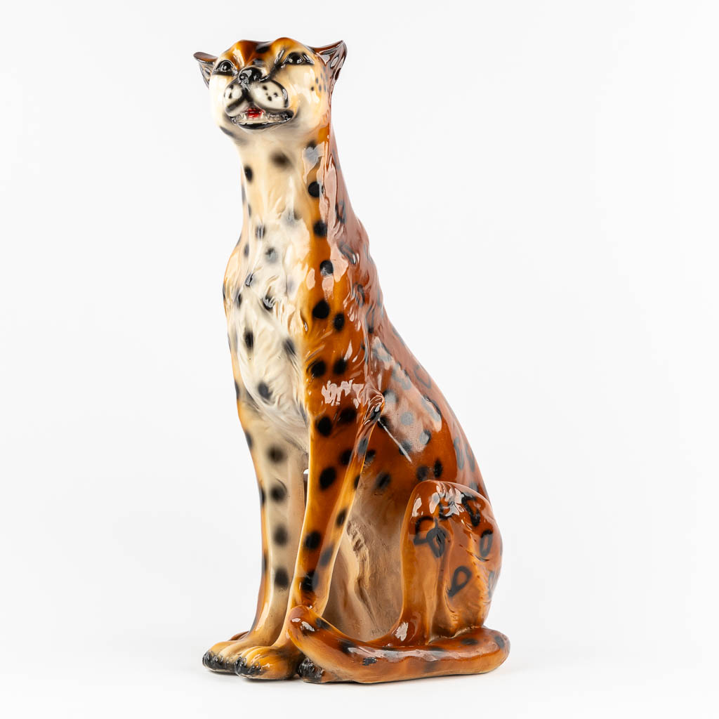 A decorative figurine of a leopard, patinated resine. 