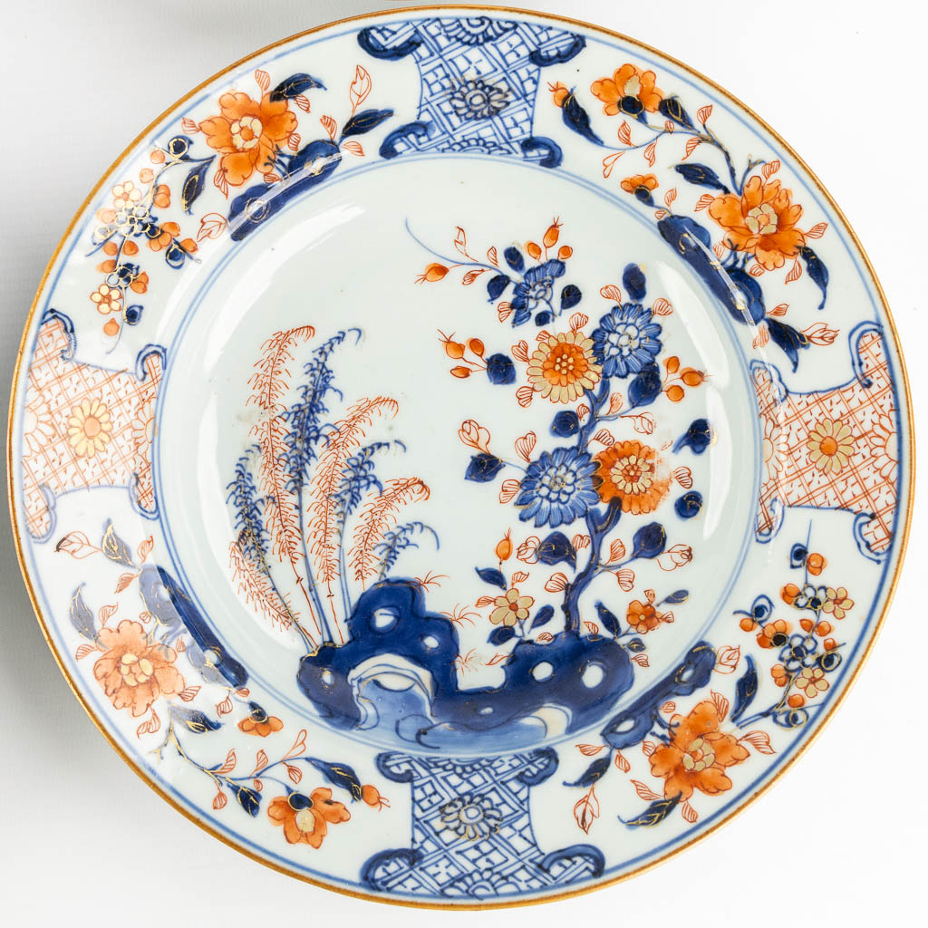 Negen Chinese Imari stijl borden met een floraal decor. 18de eeuw. (D:23 cm)