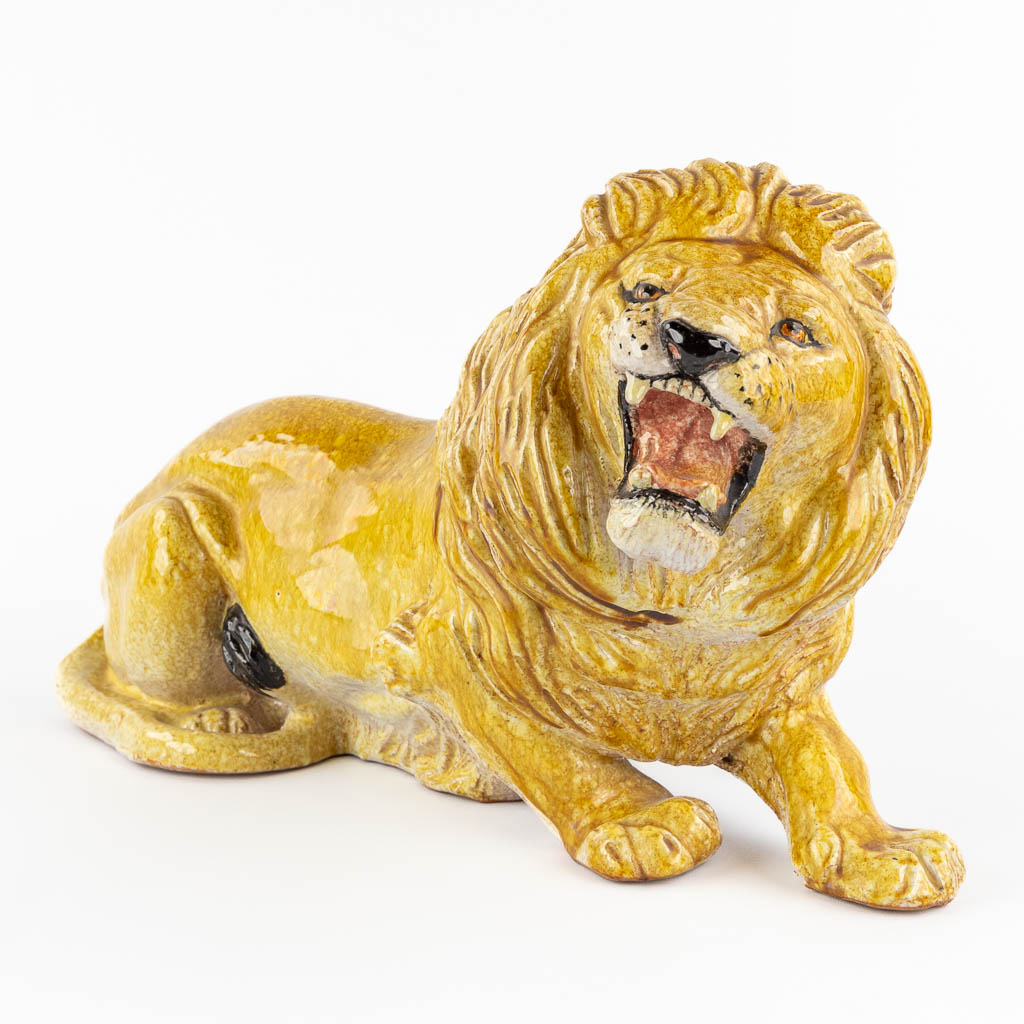 A decorative lying lion, glazed terracotta. Italy, circa 1960-1970. 