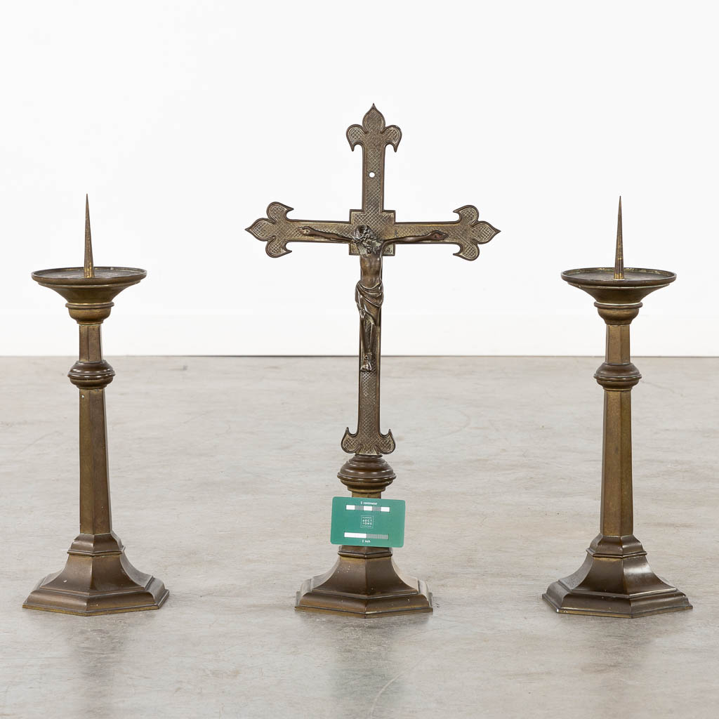 An altar crucifix with two matching candelabra, patinated bronze. Gothic Revival, Circa 1900. (W:29,5 x H:58 cm)