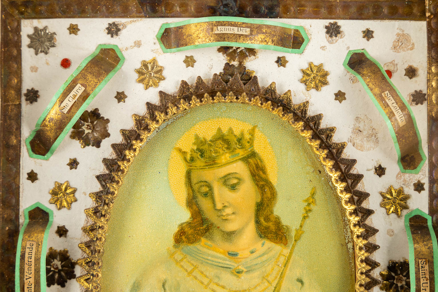 A vintage reliquary frame with 8 relics, in the middle an image of 