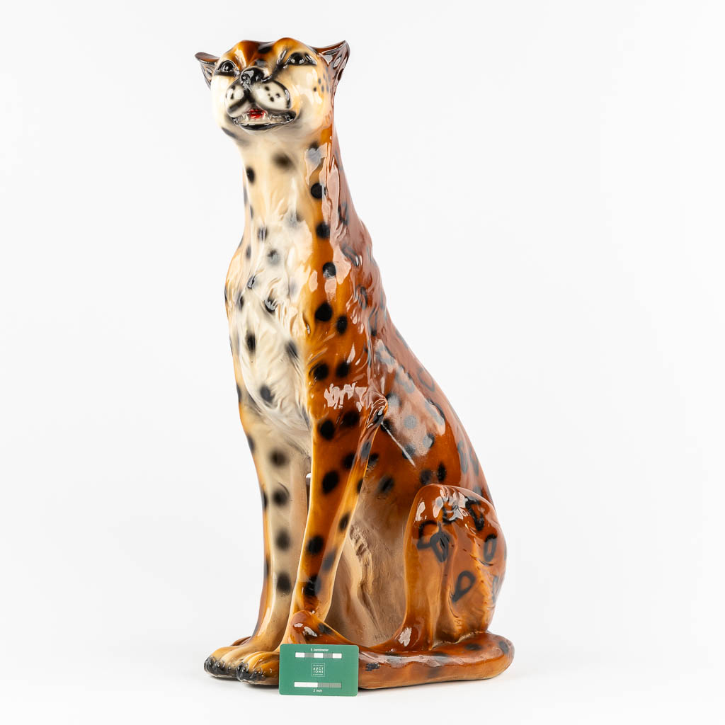 A decorative figurine of a leopard, patinated resine. 