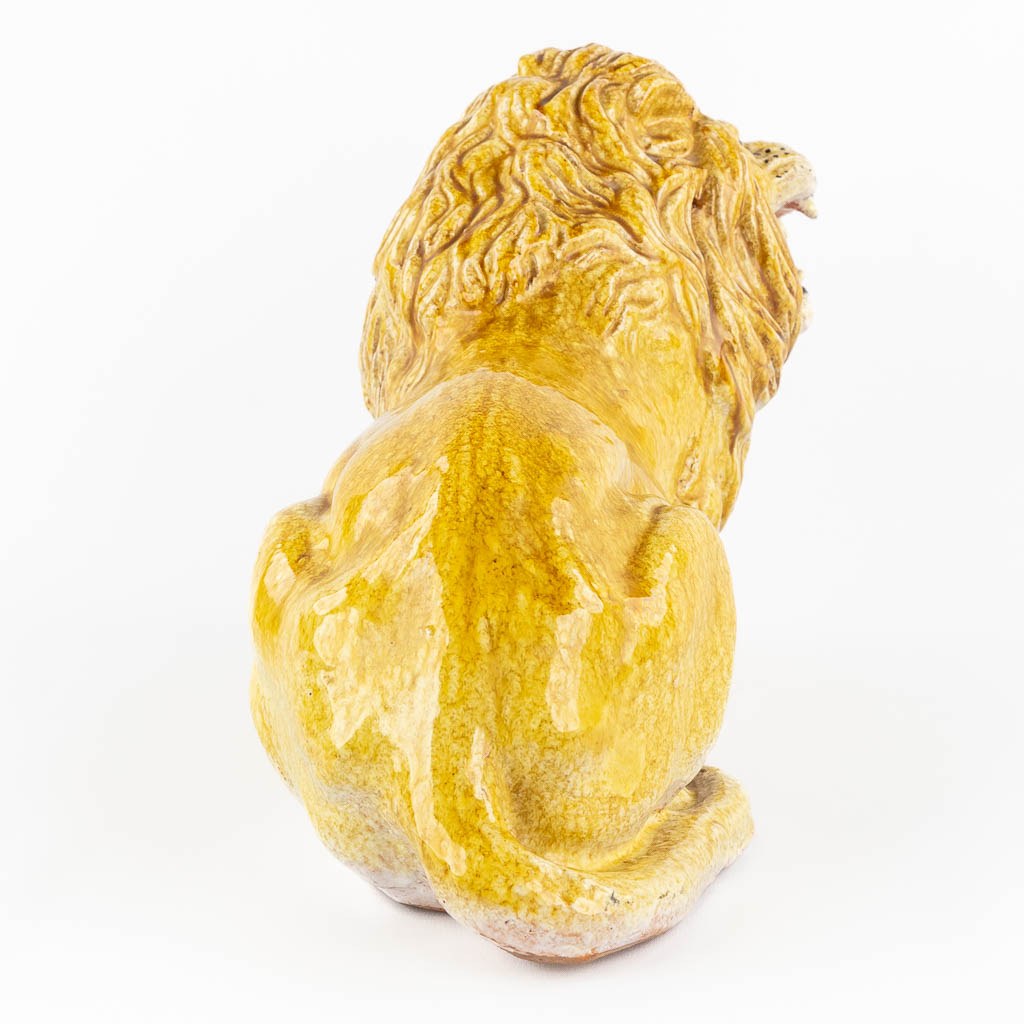 A decorative lying lion, glazed terracotta. Italy, circa 1960-1970. 