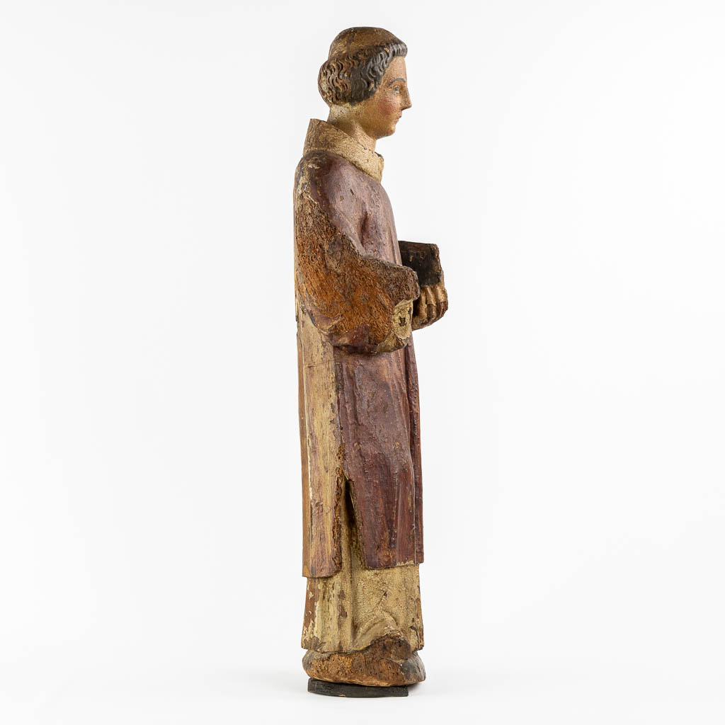 Saint Laurentius, Deacon. A wood-sculpture, oak, 14th C.  (L:20 x W:25,5 x H:90 cm)