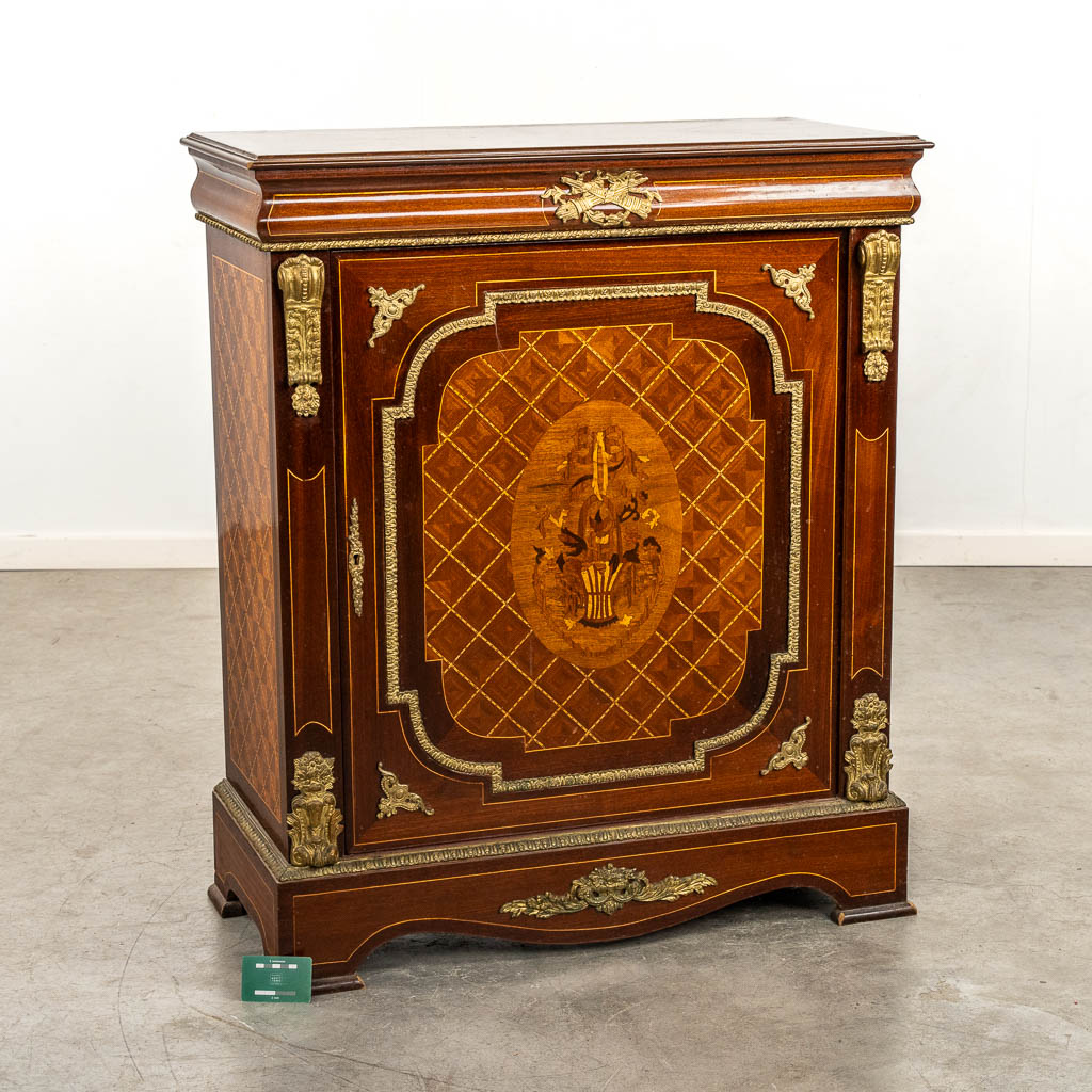 A single door cabinet, marquetry inlay mounted with bronze. 20th C. 