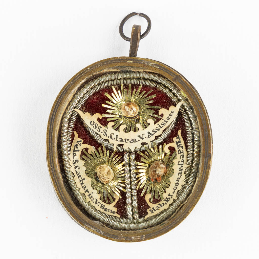 Een hanger met multi theca en drie relikwieën: Clara of Assisi, Saint Leonardi and Saint Catherin. (W:4,5 x H:5,5 cm)