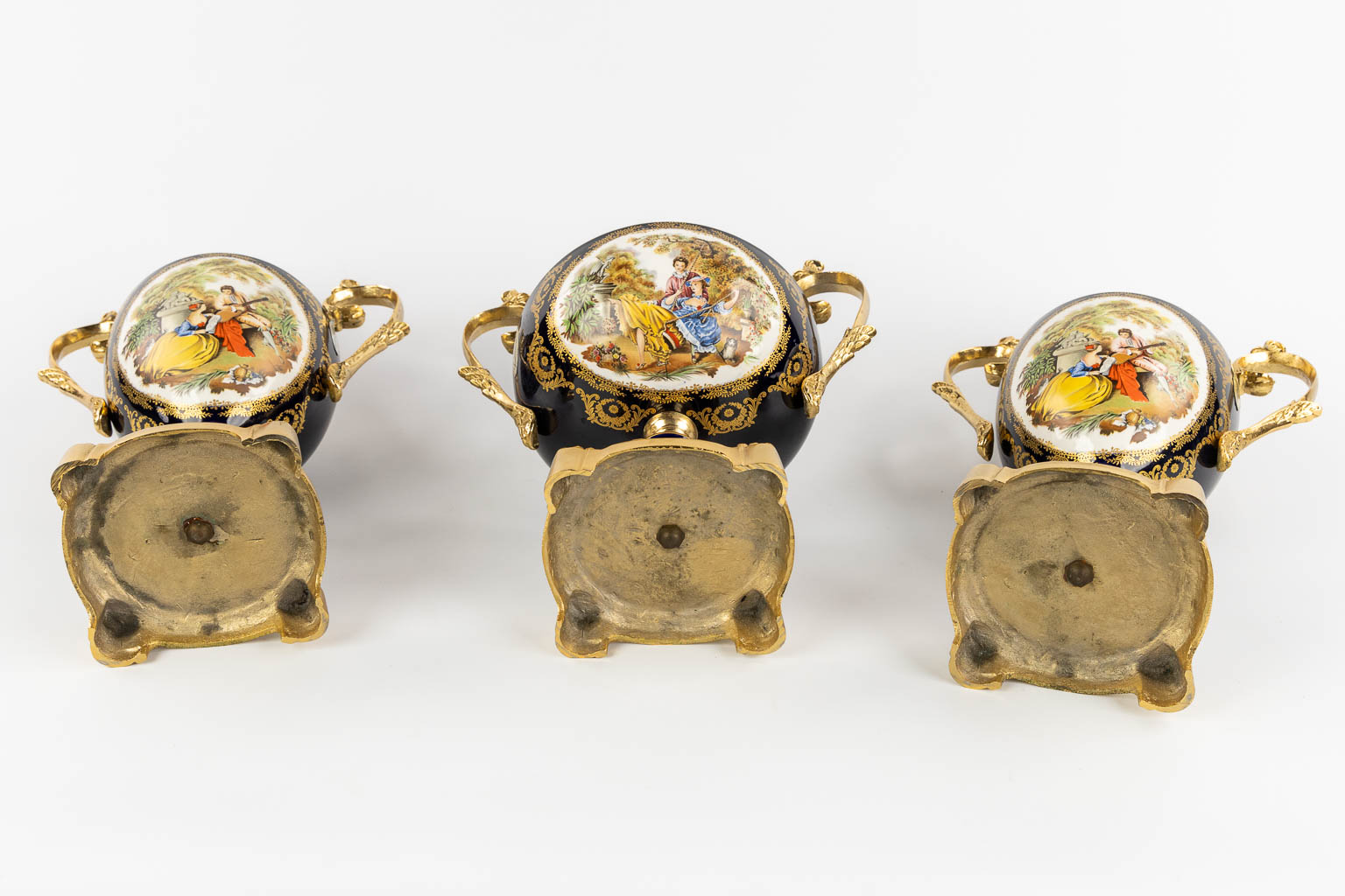 Limoges, a three-piece mantel garniture, porcelain mounted with bronze. 20th C.