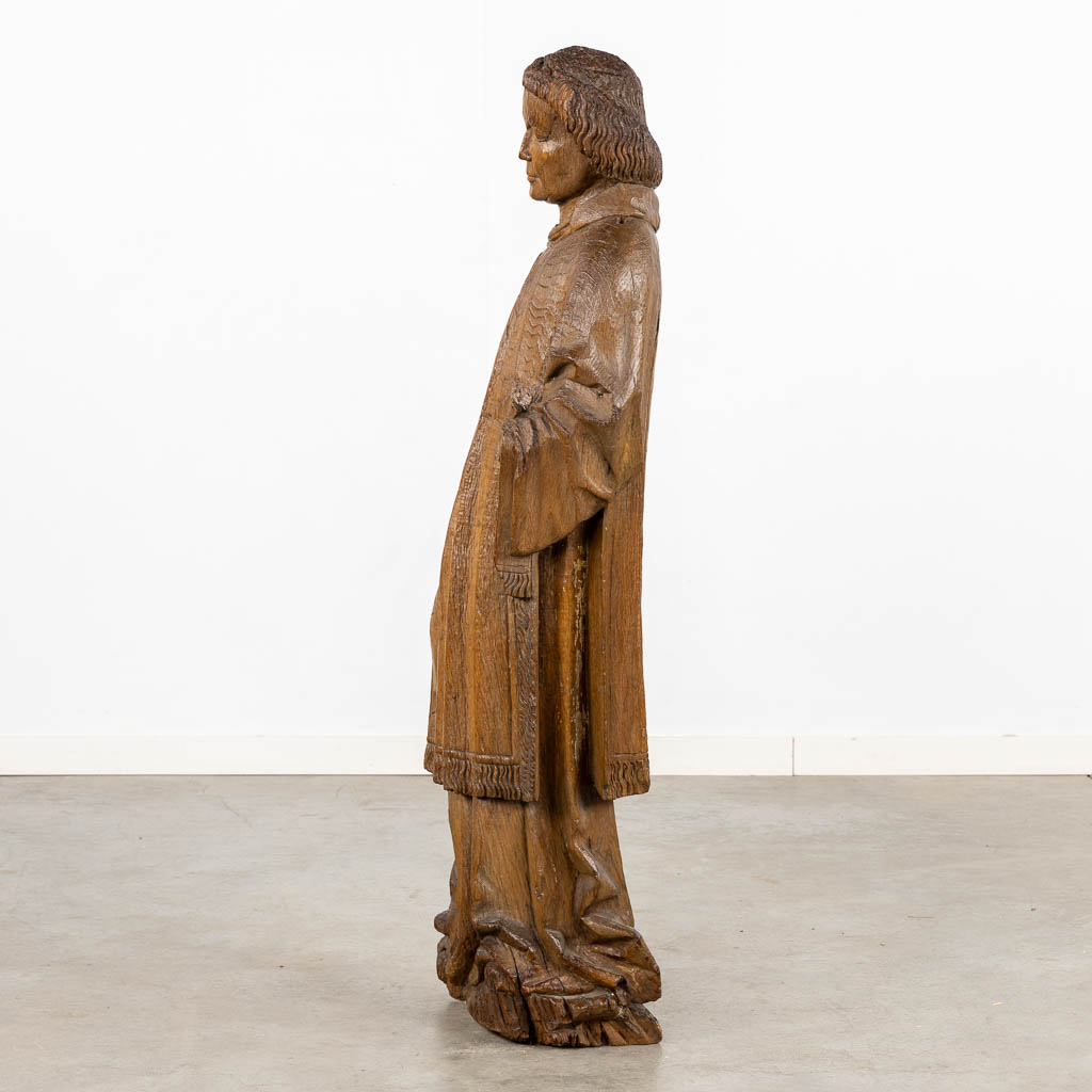 An antique, wood-sculptured figurine of Dacon Laurentius, Gothic, circa 1400. (L:22 x W:36 x H:117 cm)