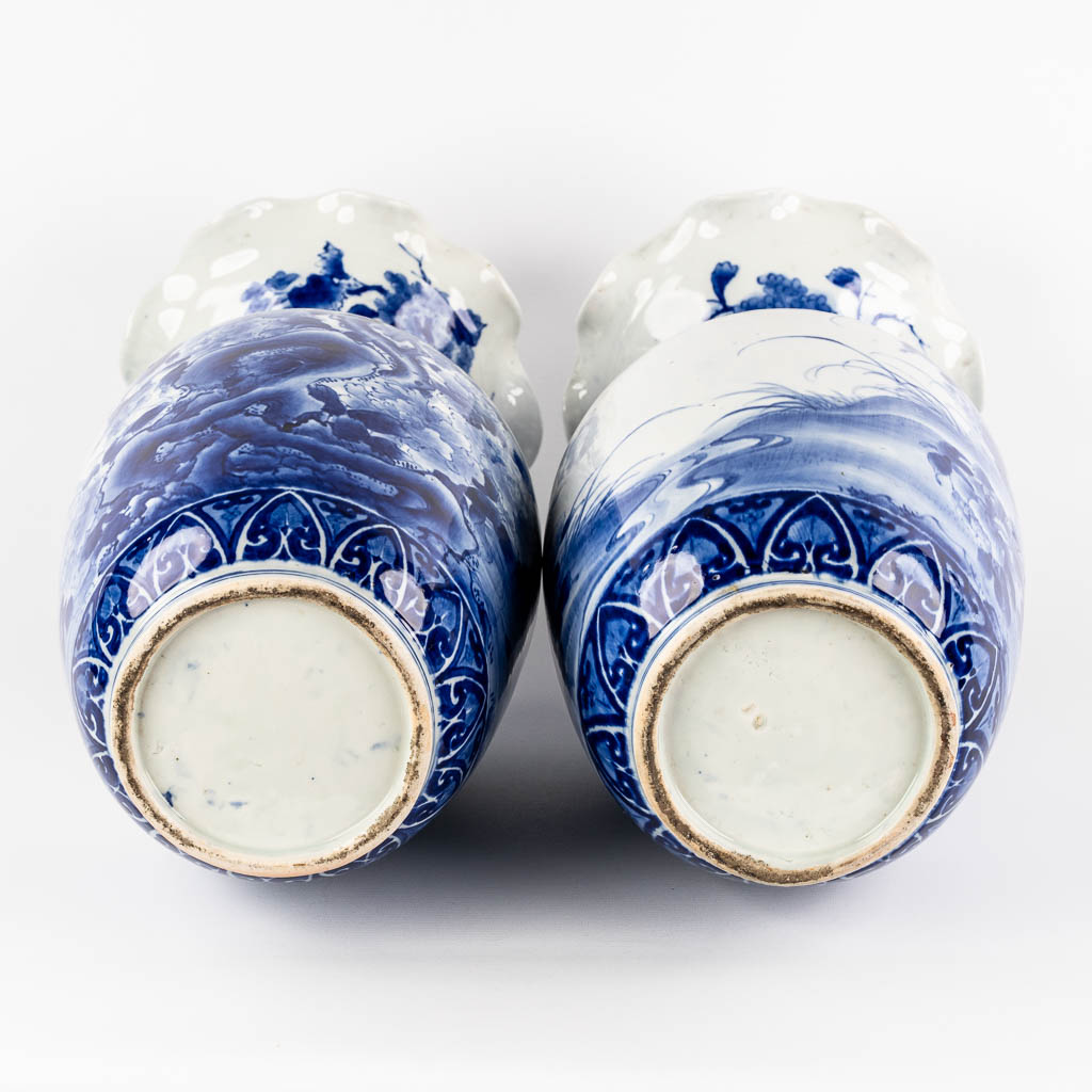 A pair of Japanese vases, Blue-white with a floral decor. 