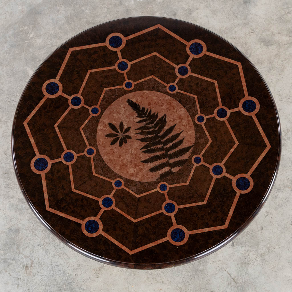 A decorative side table with a Fern and a geometric decor.