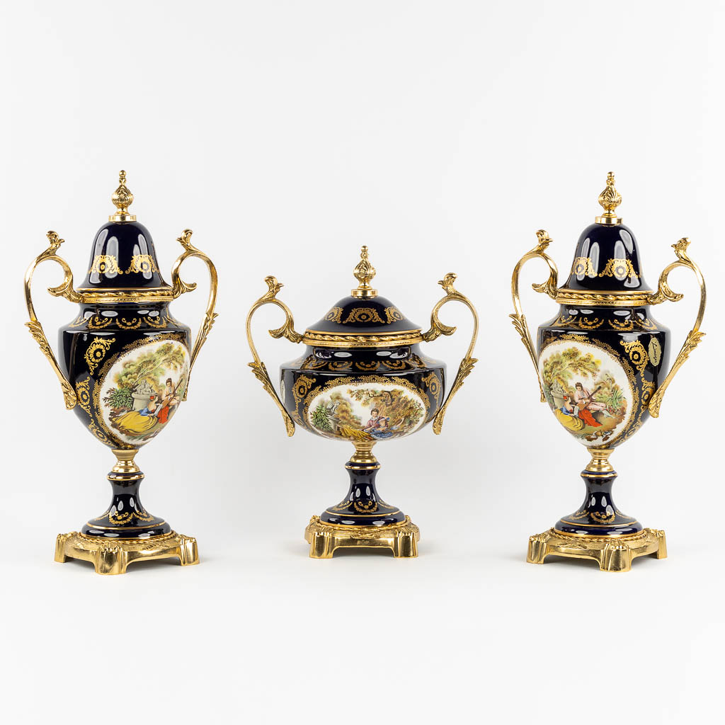 Limoges, a three-piece mantel garniture, porcelain mounted with bronze. 20th C.