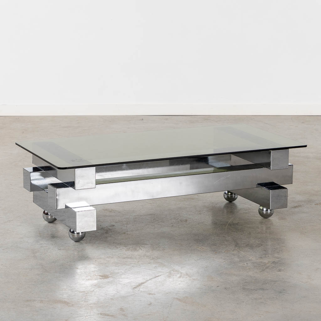 A coffee table, chromed steel and glass. (L:52 x W:104 x H:31 cm)