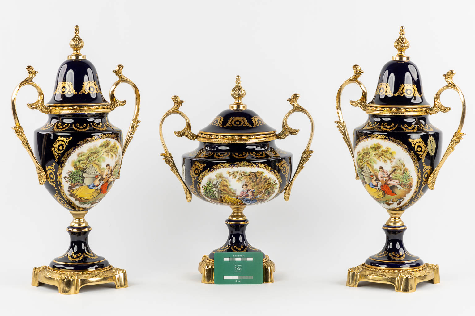 Limoges, a three-piece mantel garniture, porcelain mounted with bronze. 20th C.