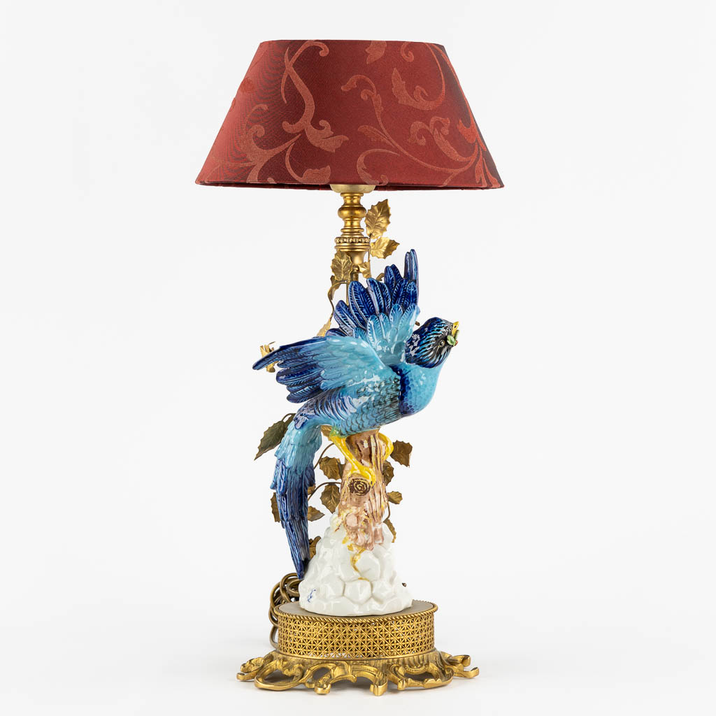 A decorative table lamp, brass mounted with polychrome porcelain. (L:16 x W:18 x H:45 cm)