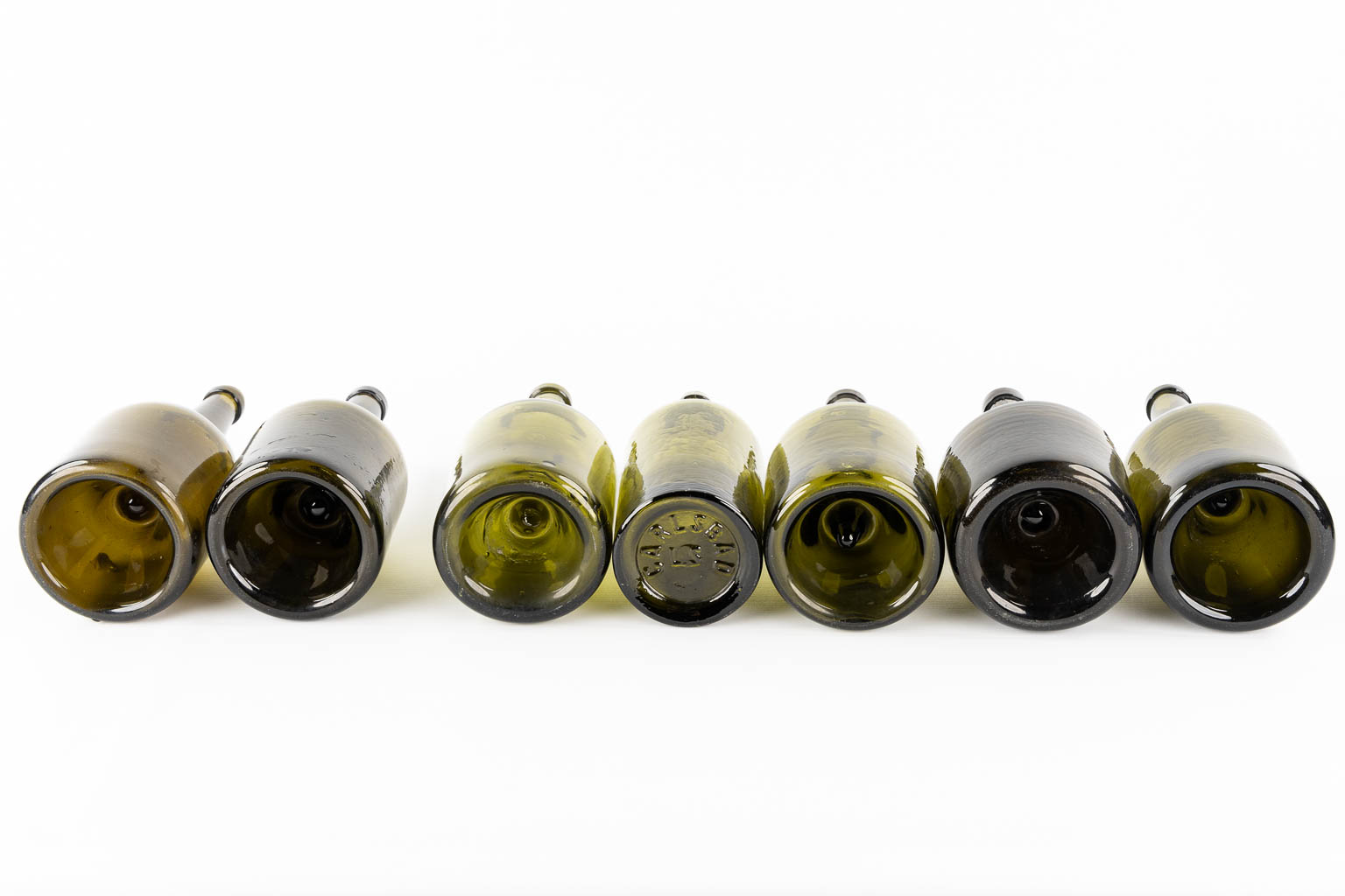 Fourteen antique glass bottles. Olive green glass. 18th and 19th C.