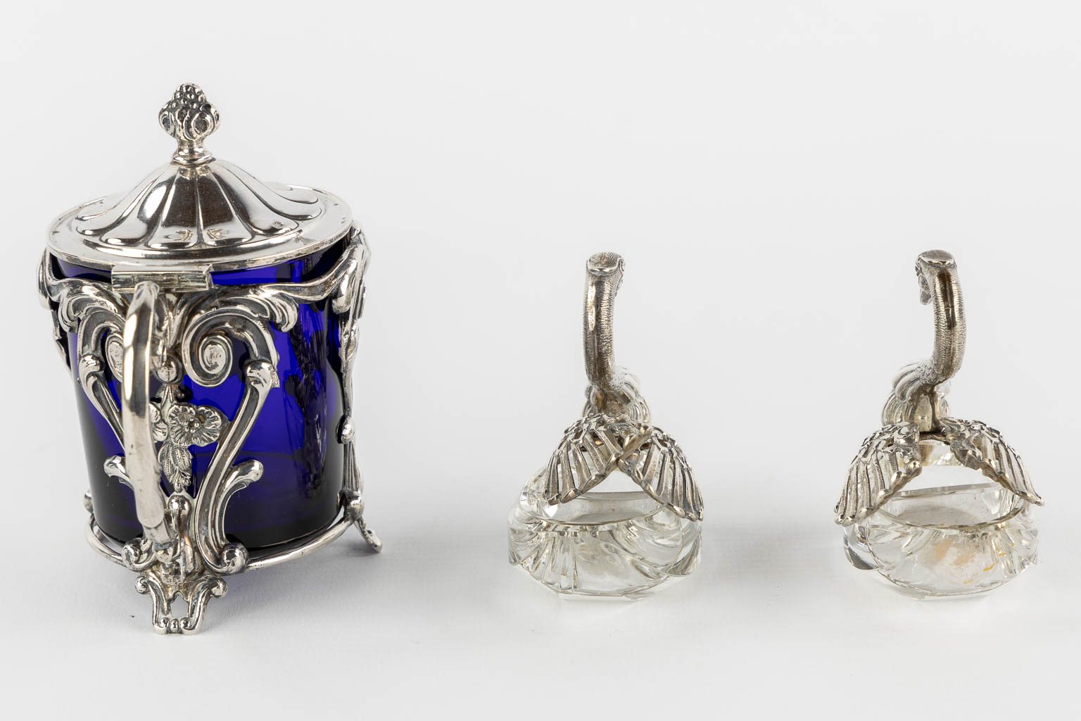 A collection of silver table accessories, oil/vinegar, salt/pepper, mustard pot, and mirror. (L:9 x W:21 x H:26 cm)