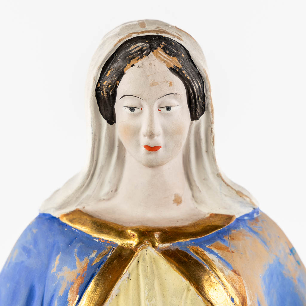 A patinated terracotta figurine of The Virgin Mary. (c1900)