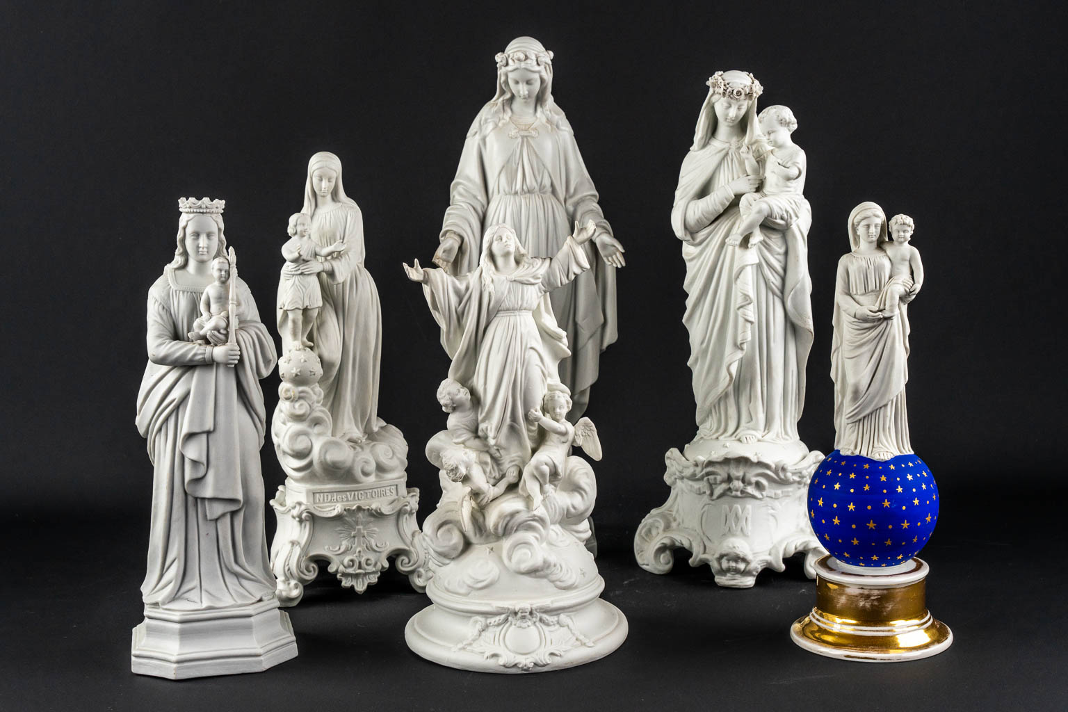 6 bisque porcleain depictions of the Virgin Mary with and without a Child. 19th C. (H:46 cm)