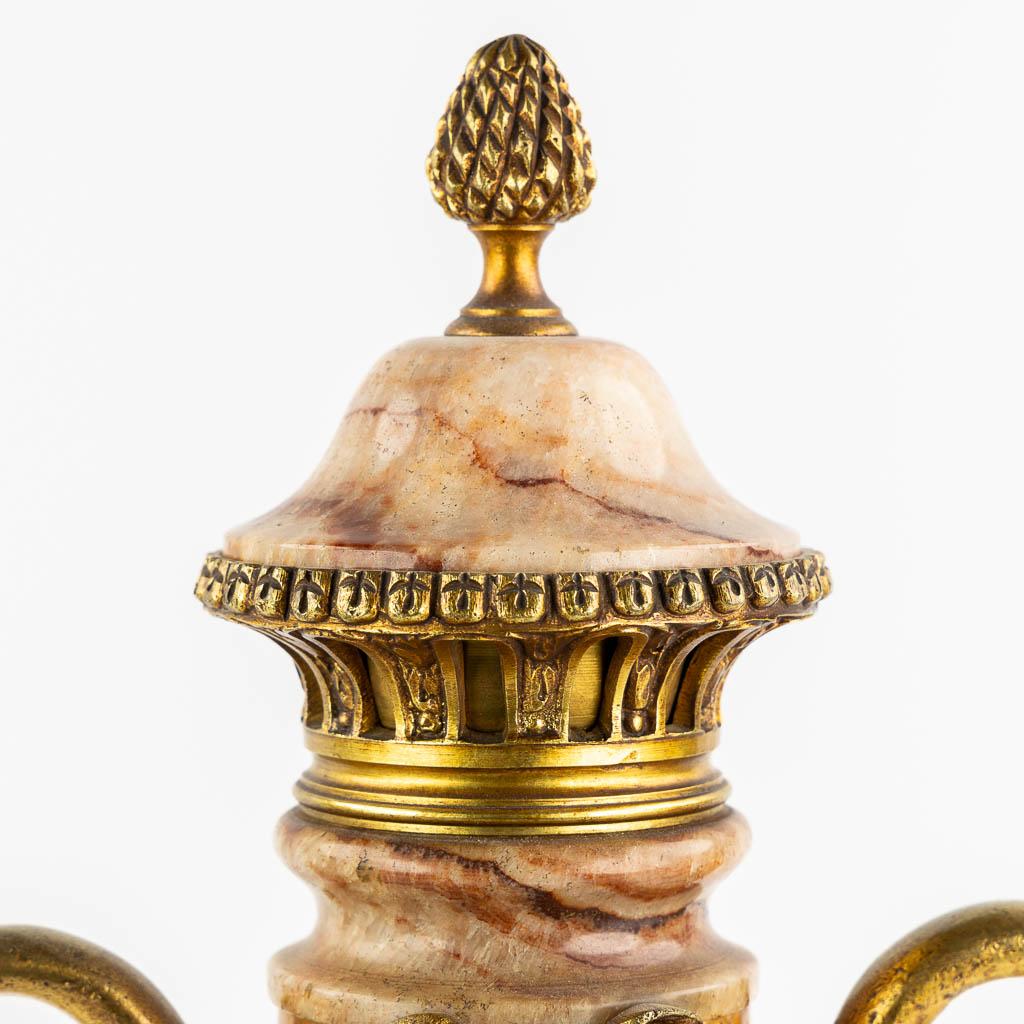 A pair of marble and bronze cassolettes in Empire style, decorated with swans. Circa 1880. (L:17 x W:21 x H:53 cm)