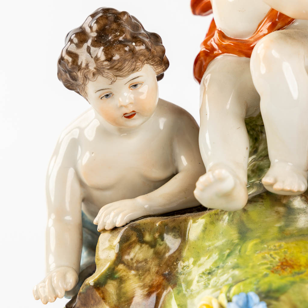 Volkstedt, Rudolstadt, a polychrome porcelain group with putti. (L:12,5 x W:23,5 x H:24 cm)