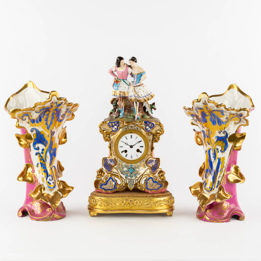 A three-piece mantle garniture clock and side pieces, polychrome porcelain in the style of Jacob Petit. 19th C.