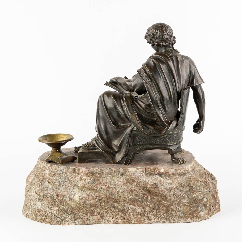 The Reading Roman, patinated bronze. 19th C. (L:23 x W:38 x H:34 cm)