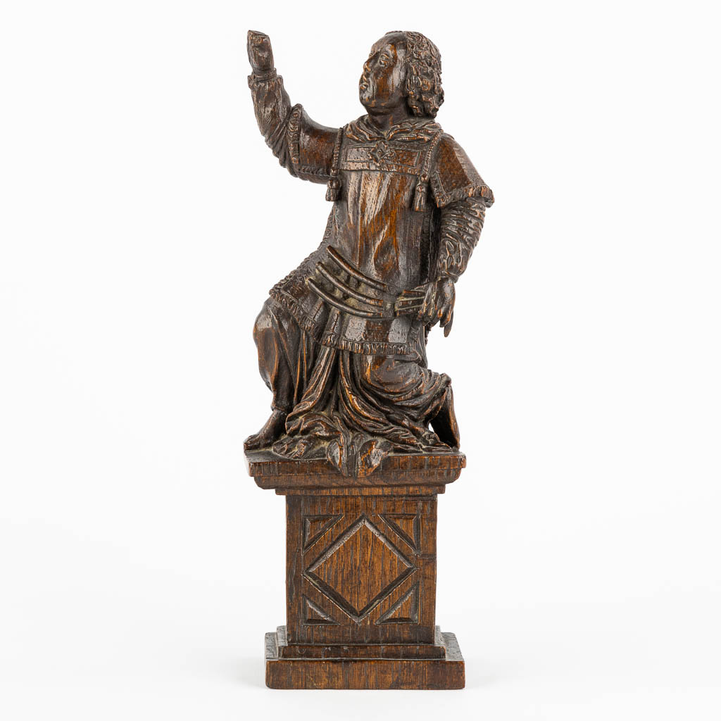 An antique wood-sculptured figurine of a saint holding a scourge. 17th C. (W:10 x H:29 cm)