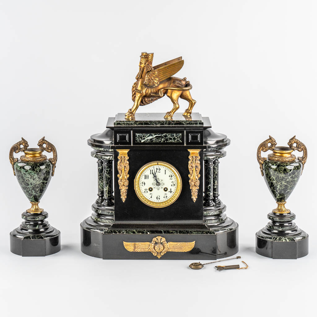 A Neoclassical three-piece mantle garniture clock and side pieces, marble and bronze. 19th C.