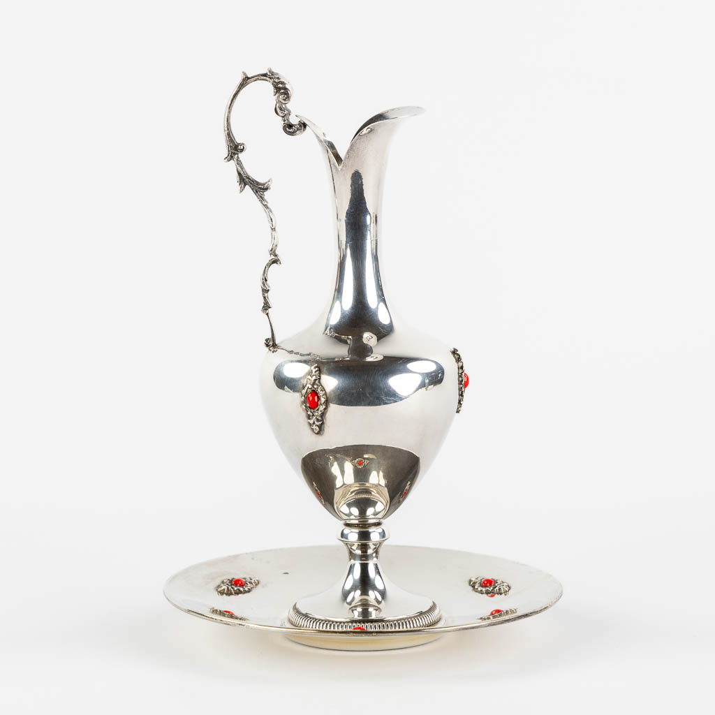 A pitcher on a saucer, silver mounted with cabochons. 800/1000. (H:22 x D:16 cm)