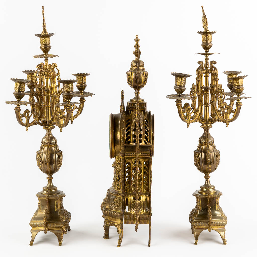 A three-piece mantle garniture clock and candelabra, bronze. 20th C. (L:12 x W:28 x H:51 cm)