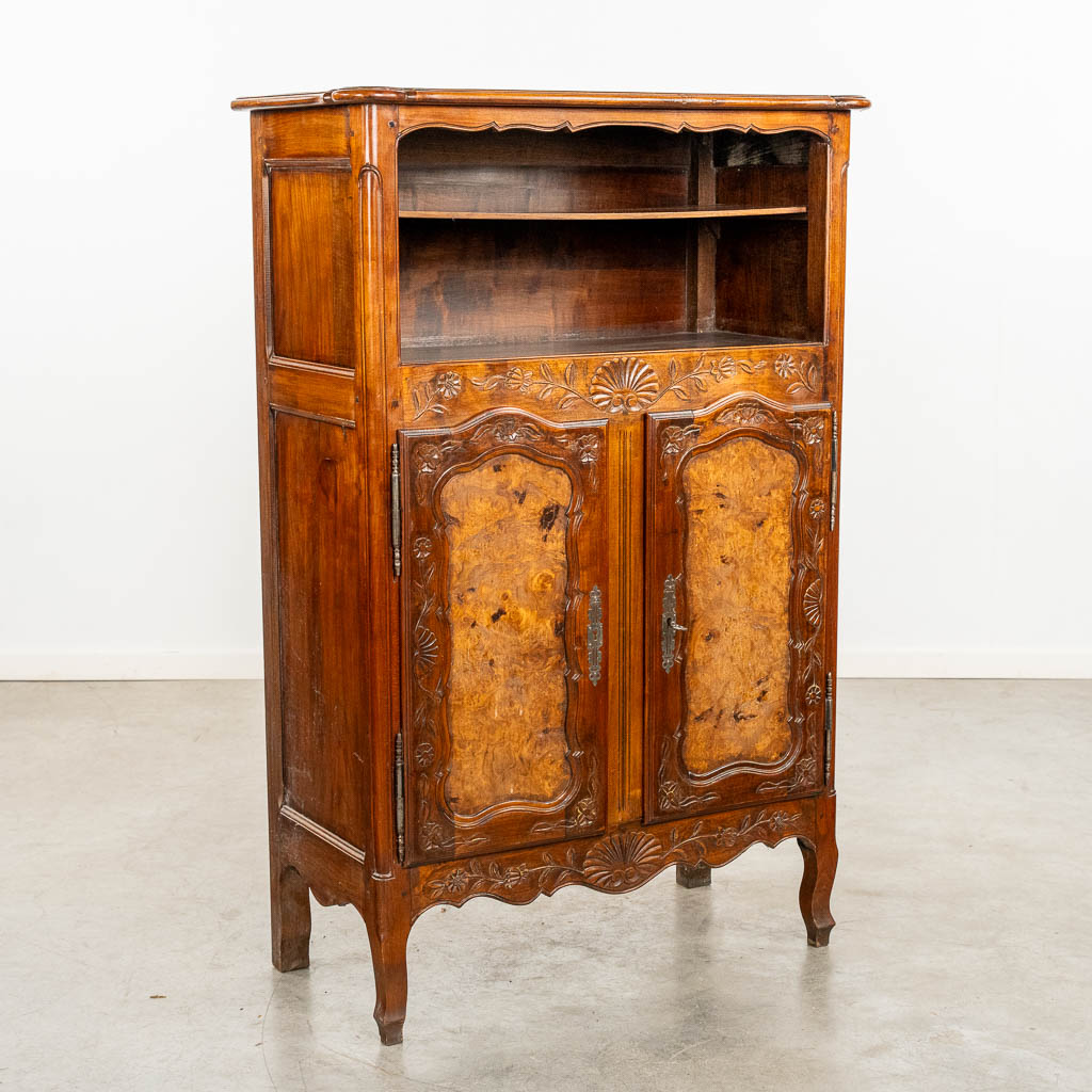 A two door-cabinet, sculptured wood finished with root-wood veneer. 