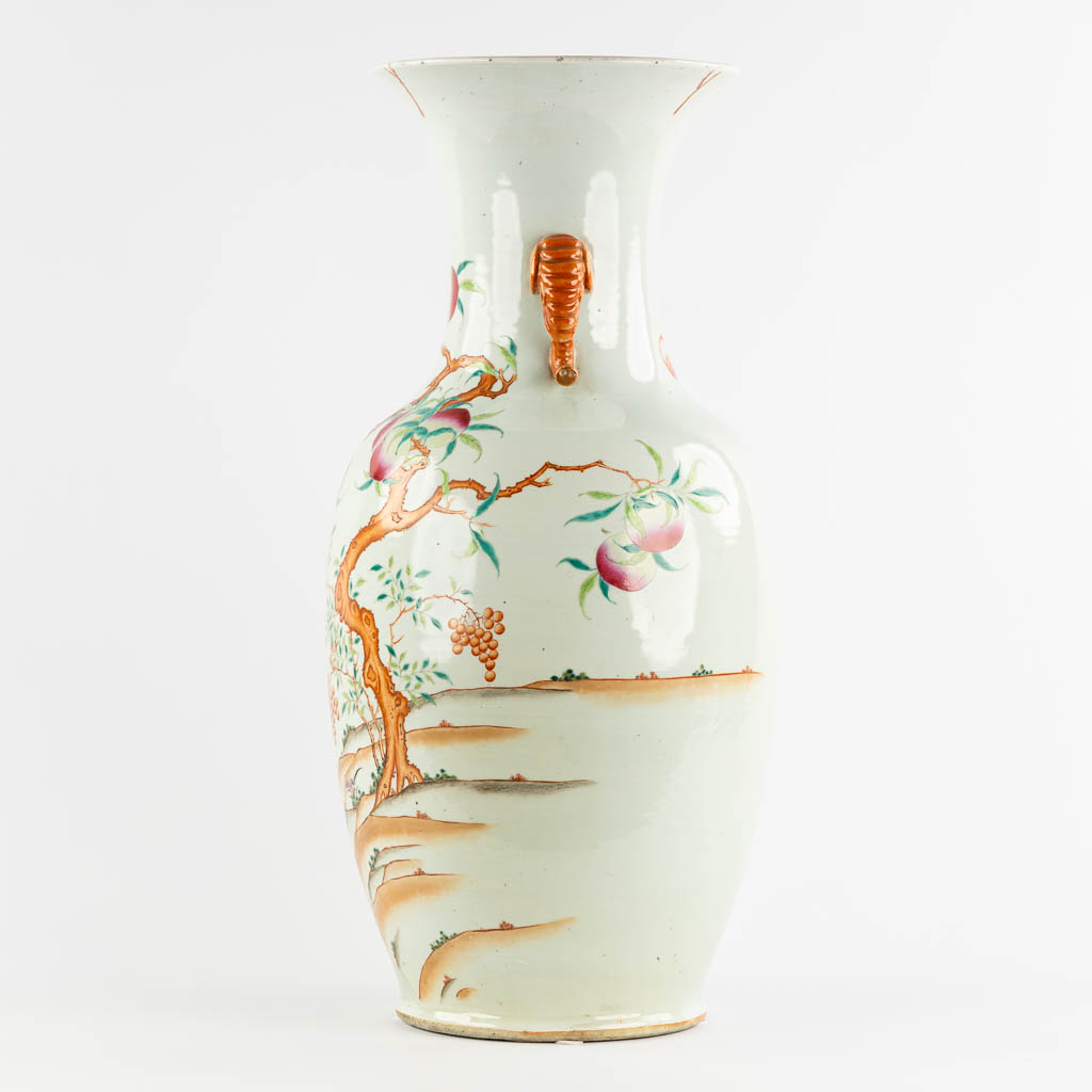 A large Chinese Famille Rose vase with a peach decor and elephant handles. 19th C. (H:70 x D:34 cm)