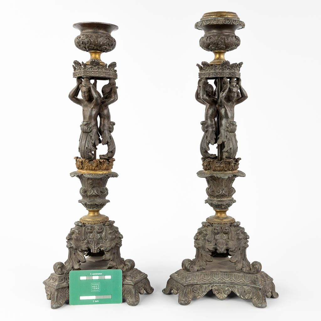 A pair of candlesticks decorated with Karyatids. Spelter and bronze. 19th C. (L:17 x W:17 x H:48 cm)