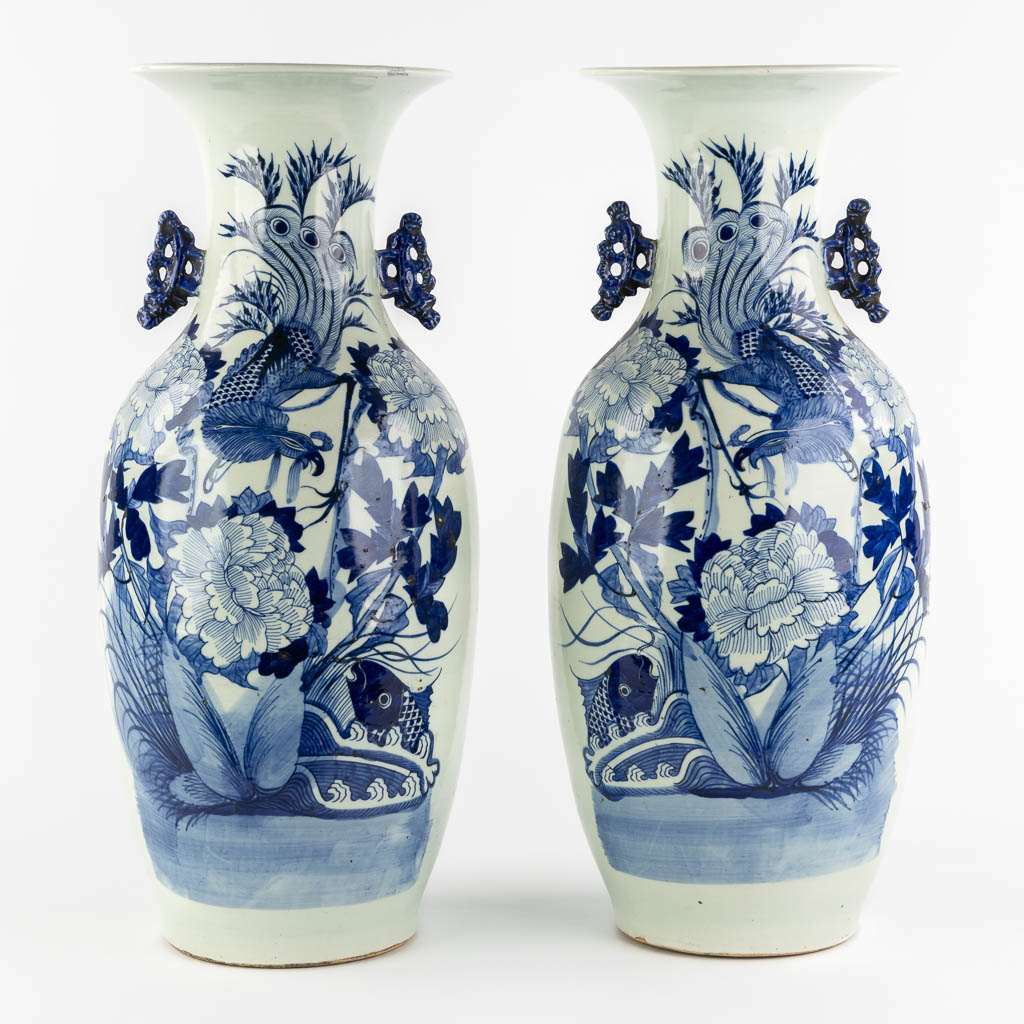 A pair of Chinese vases, blue-white decor of flowers and birds and a fish. (H:57 x D:22 cm)