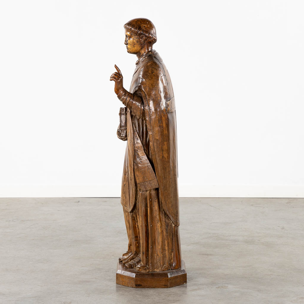 An antique wood-sculptured figurine of Saint Lawrence, 18th/19th C. (L:27 x W:33 x H:106 cm)