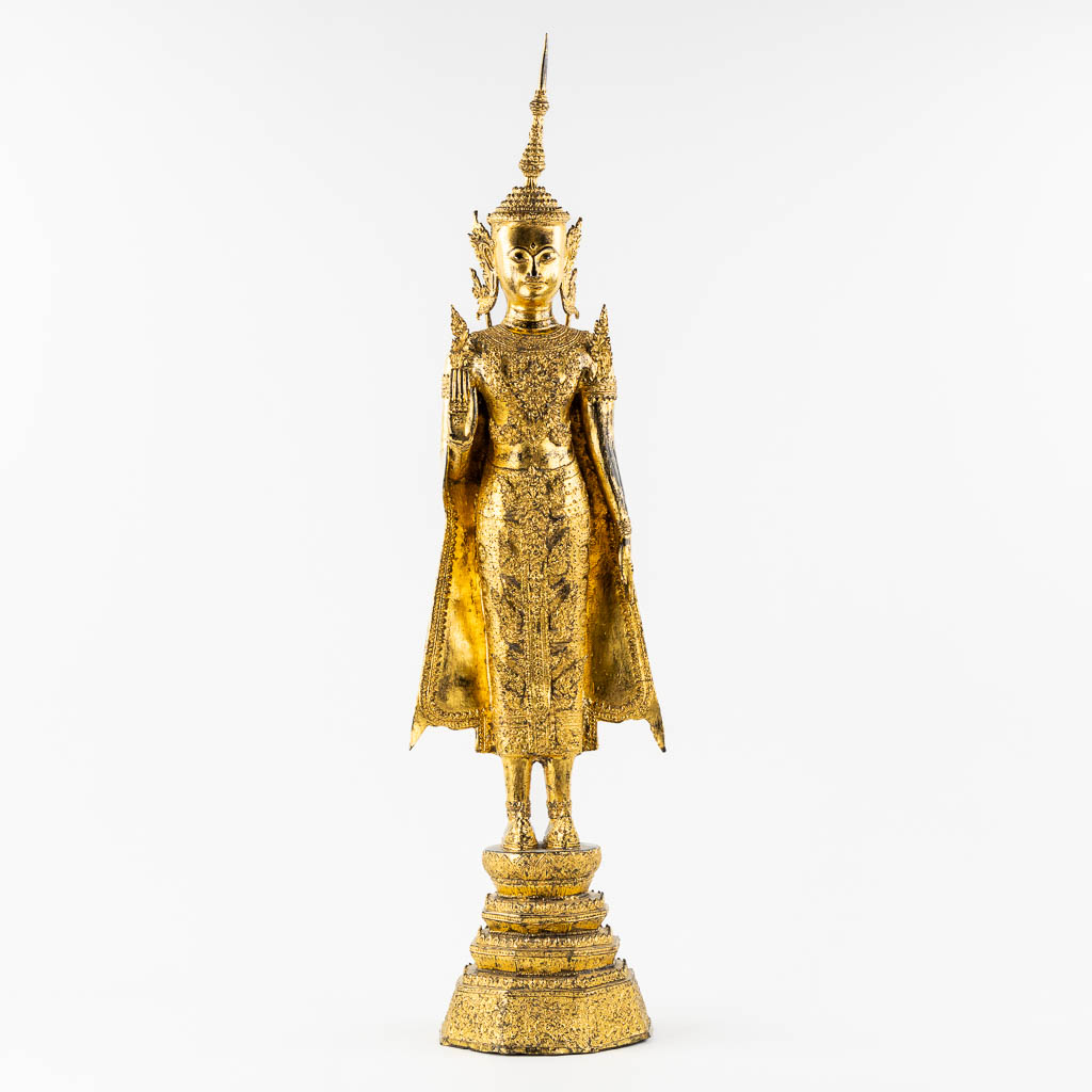 A large figurine of a standing Buddha Rattanakosin, gilt bronze. Thailand. 