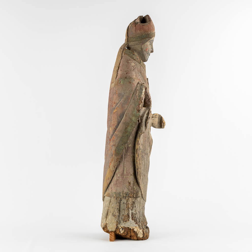 An antique wood-sculptured figurine of a Bishop, Roman, mid-13th/early 14th C. (L:23 x W:27 x H:88 cm)