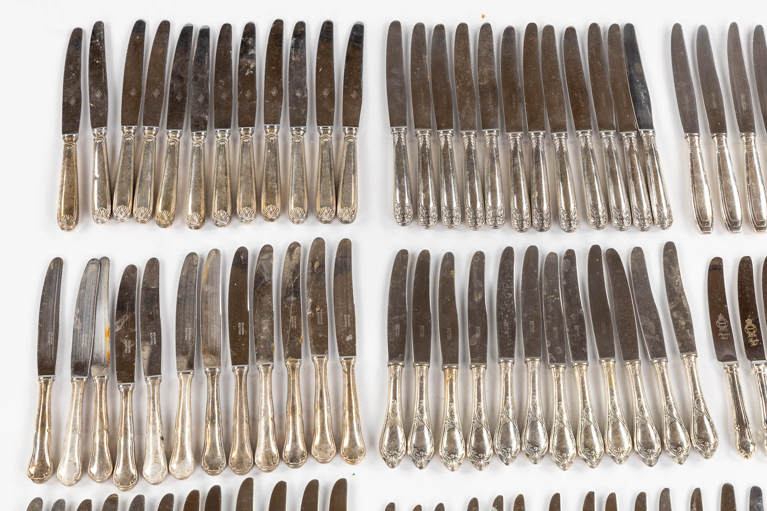 Twelve sets of twelve silver-plated knives. 