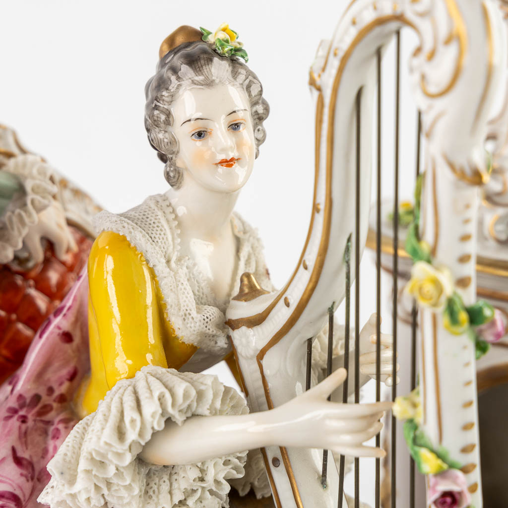 Volkstedt Rudolstadt, a large group 'Playing the harp' polychrome porcelain. 