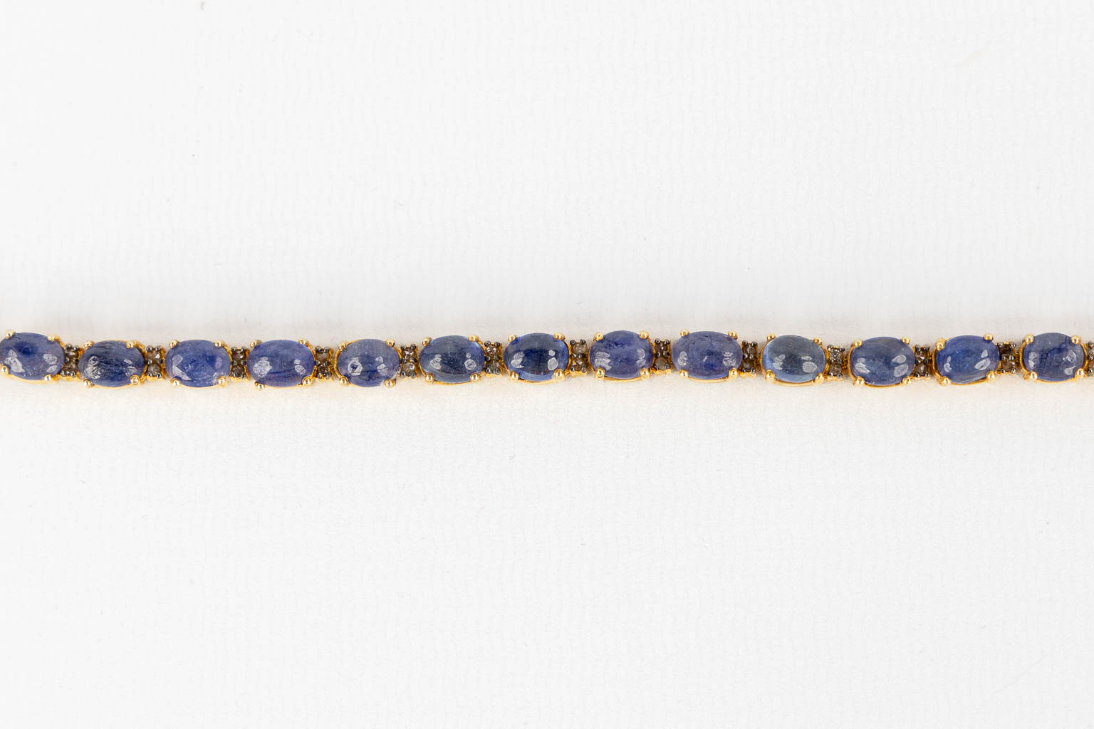 A bracelet, gilt silver with cabochon Sapphires and old cut diamonds. 23,35g. 