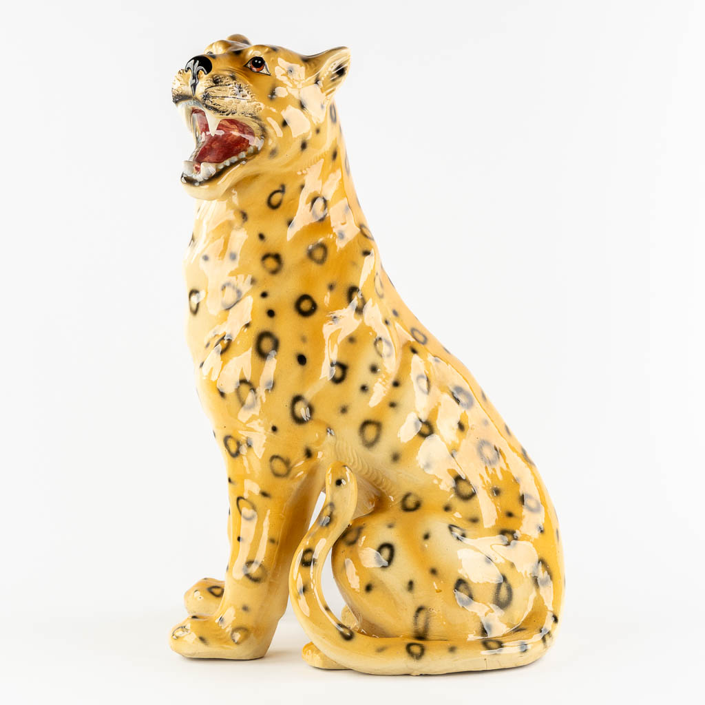 A large glazed faience Leopard, Italy, 20th C. (L:33 x W:46 x H:73 cm)