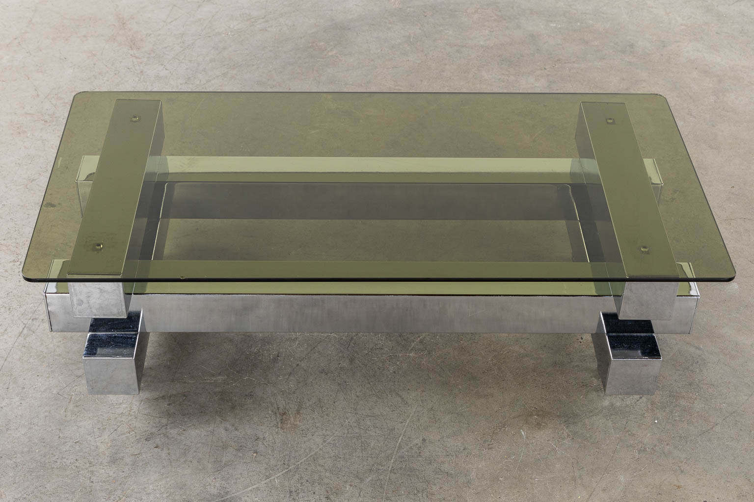 A coffee table, chromed steel and glass. (L:52 x W:104 x H:31 cm)