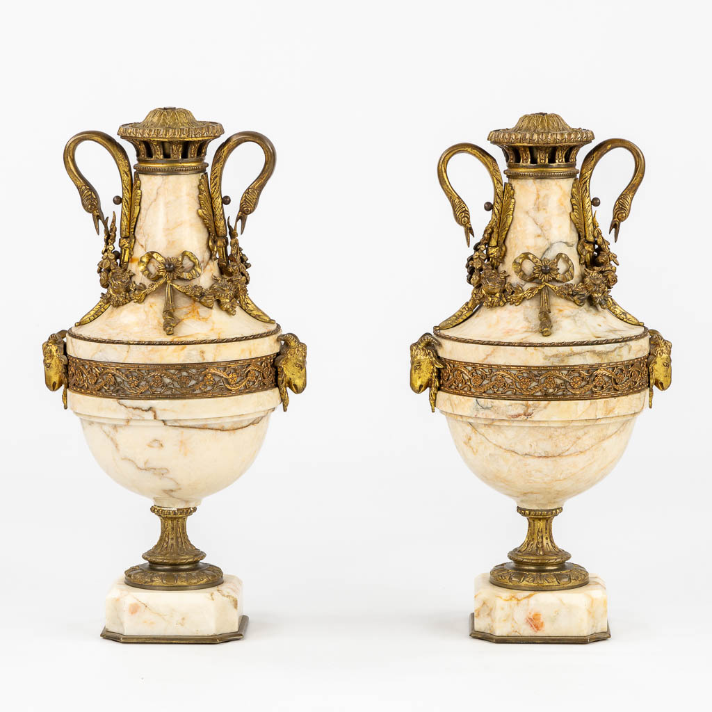 A pair of marble cassolettes, marble mounted with bronze in Louis XVI style. Ram's and Swans. (L:20 x W:25 x H:49 cm)