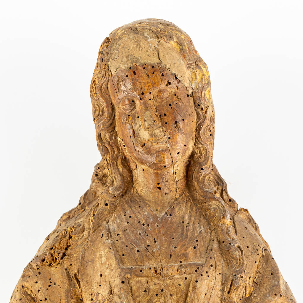 An antique wood-sculptured figurine of a saint holding a book, oak, 17th C. (L:17 x W:20 x H:53 cm)