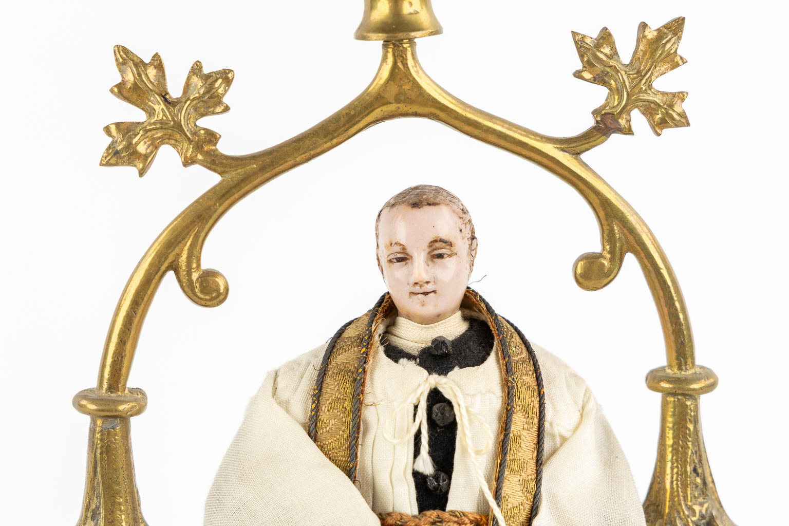 A shrine with a wax figurine of a saint, circa 1920. Gothic Revival. (L:14 x W:20 x H:33 cm)